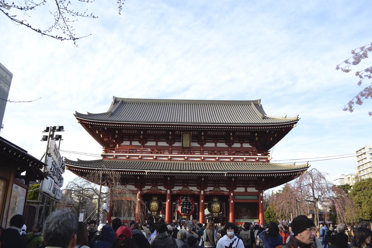traditional Japanese temple with a big crowd in front